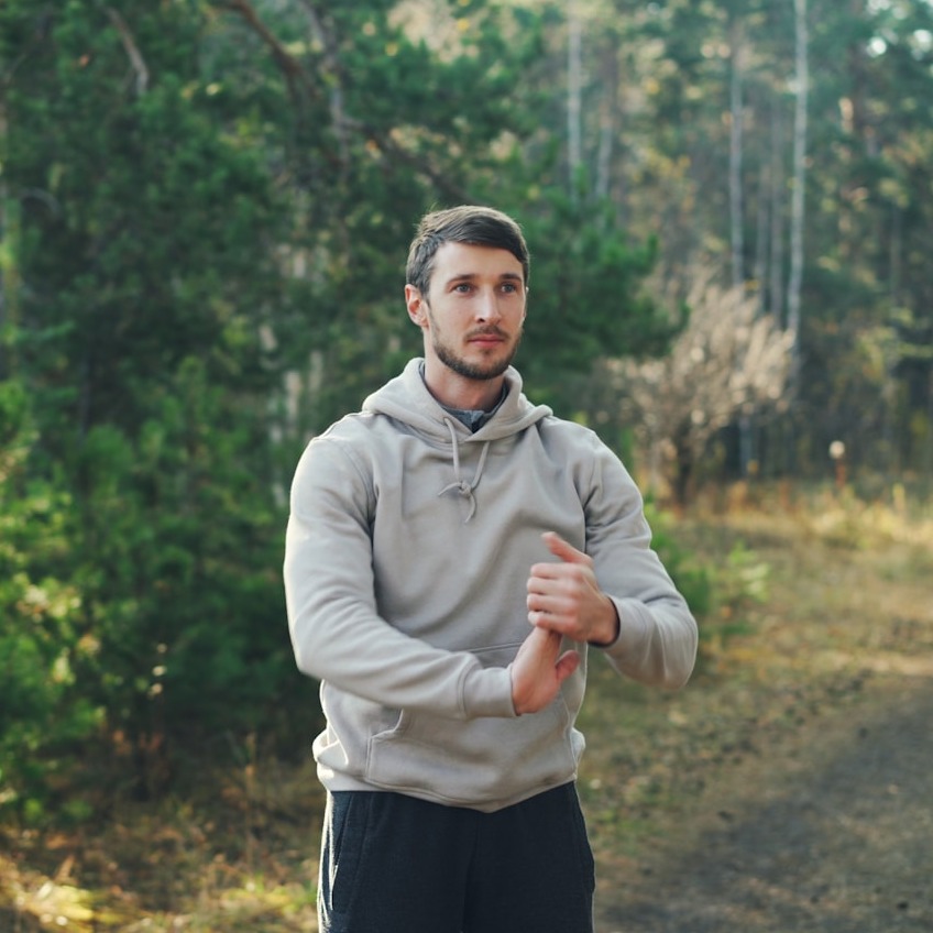 A split-screen image showing 'before' and 'after' photos of a person's posture. The 'before' image shows a person with hunched shoulders and a slight slouch, while the 'after' image shows the same person with a straight, confident posture. Use natural lighting and a neutral background to emphasize the postural changes. Focus on realism and subtle, believable improvements.