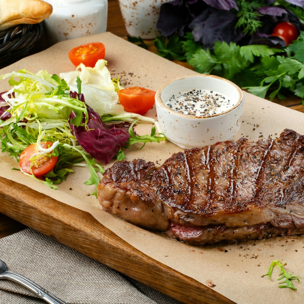 A photorealistic image of Pascal Rollet having a video call with a client. Pascal is smiling encouragingly and giving advice. The client looks engaged and motivated. Set the scene in a modern, well-lit home office. Focus on the connection and support being offered. Camera angle: medium shot from Pascal’s perspective.